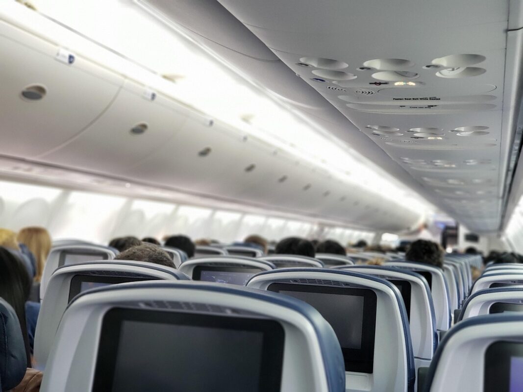Sleeping upright on a plane without wrecking your neck